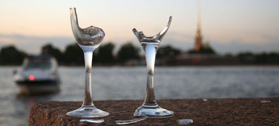 broken wine glasses near a boat