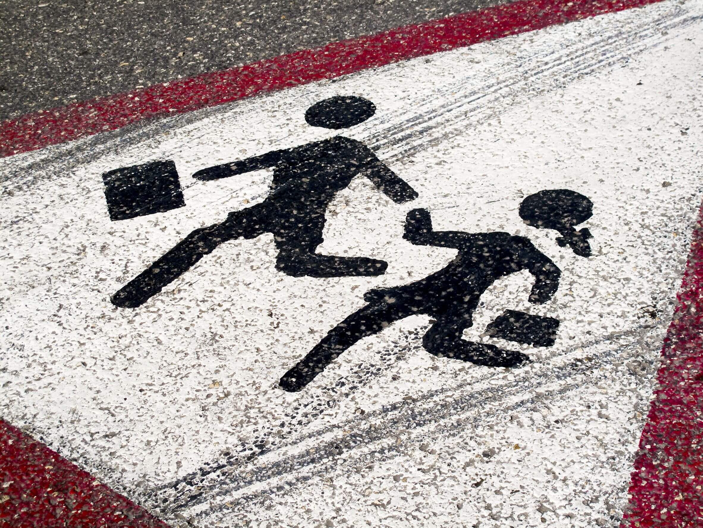 children crossing sign on pavement