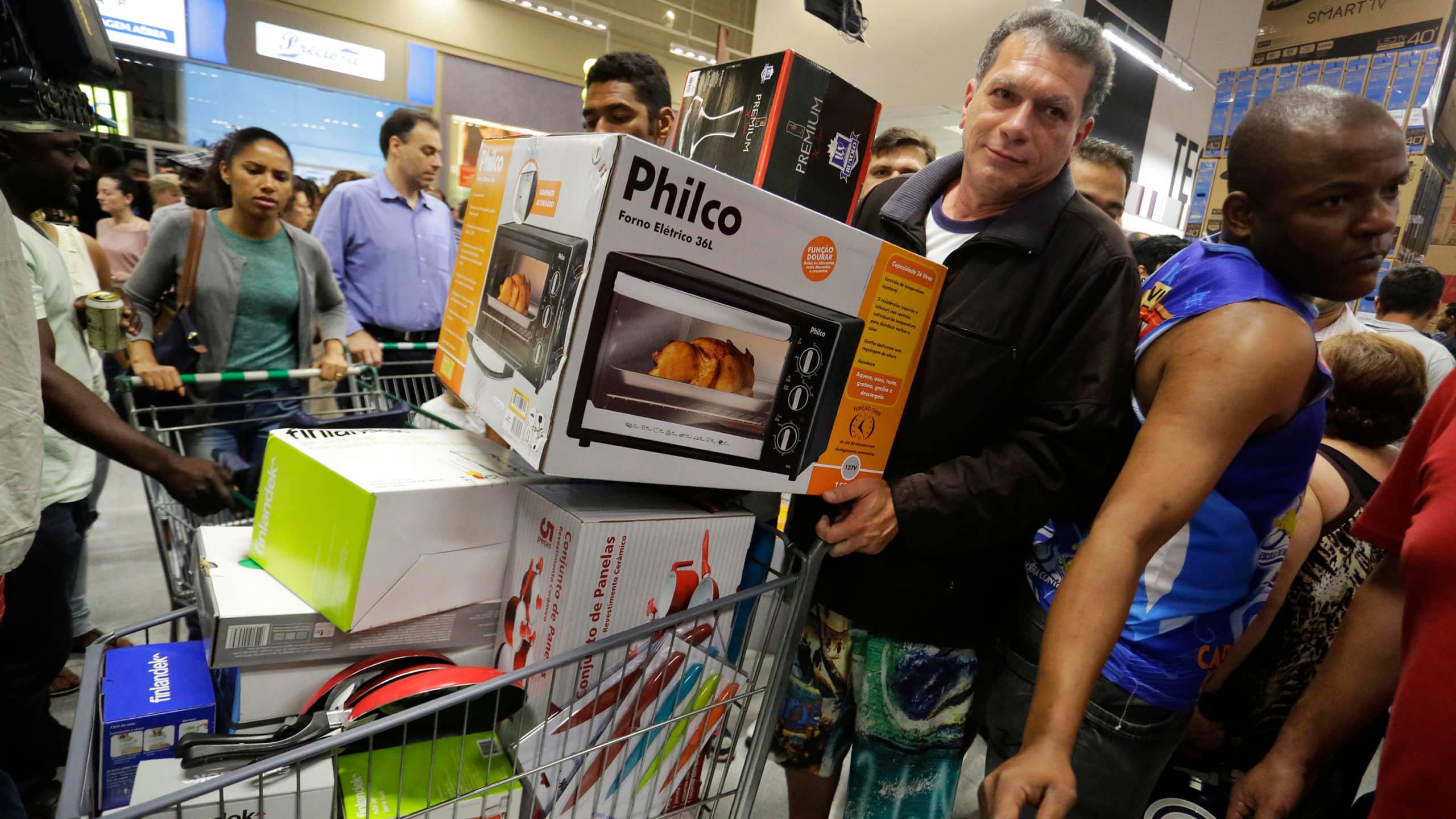 shopper filling his cart with electronics at best buy black friday sale