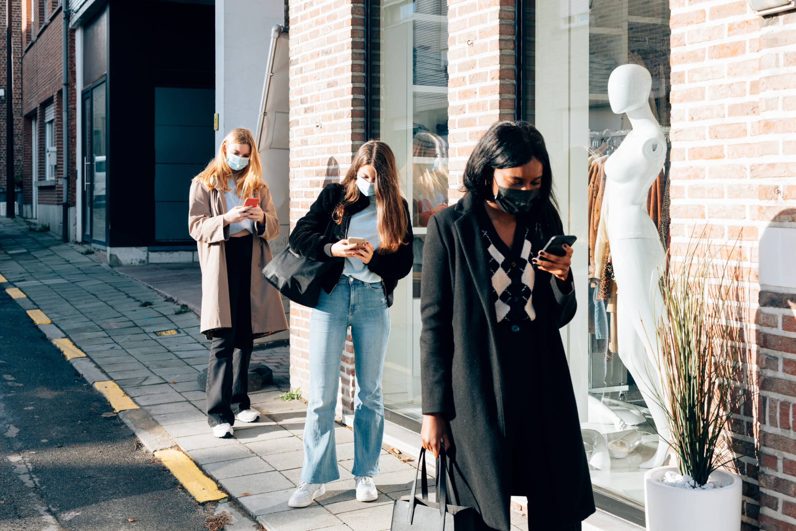 women lining up during black friday to buy clothes