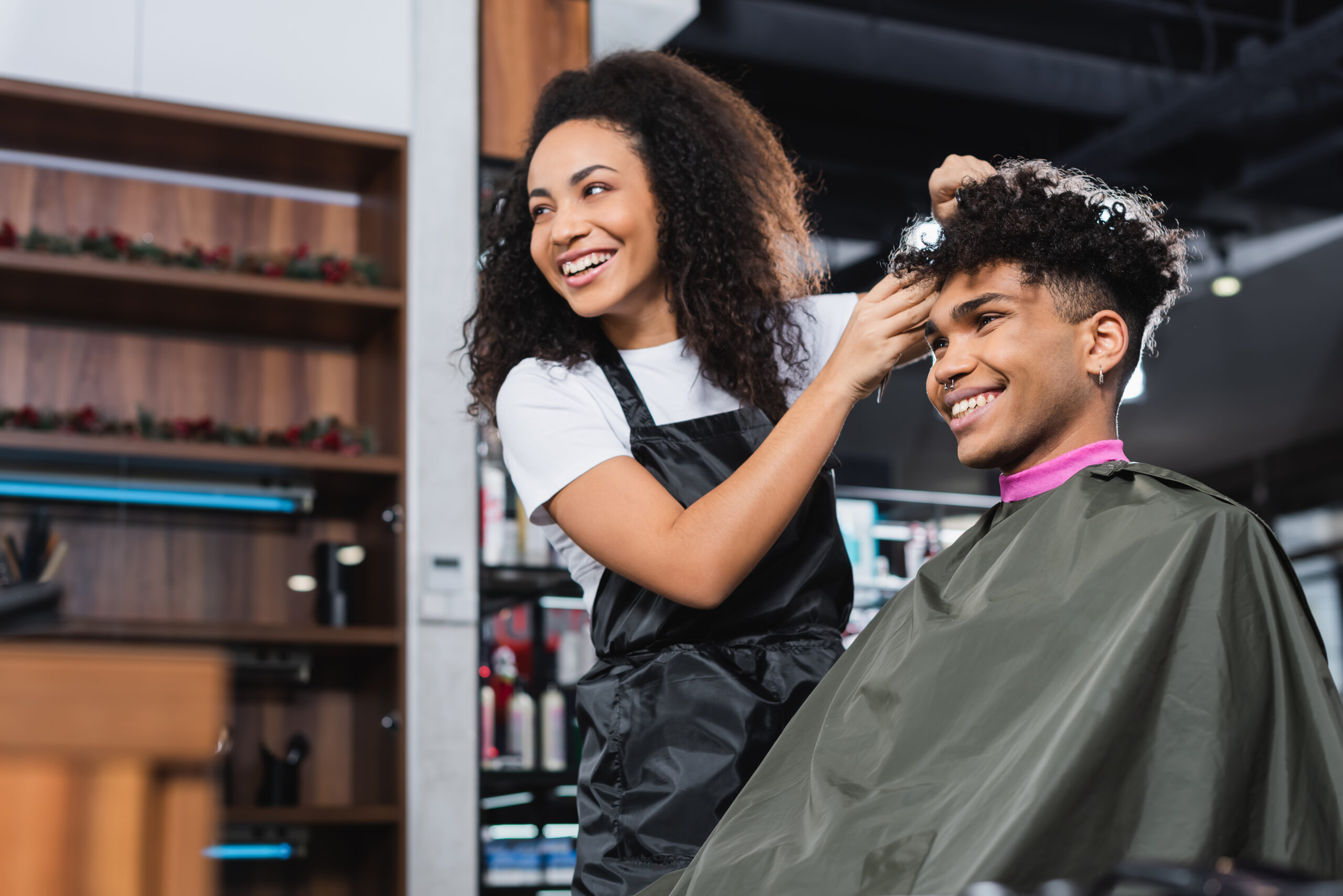 A barber cuts a customer's hair.