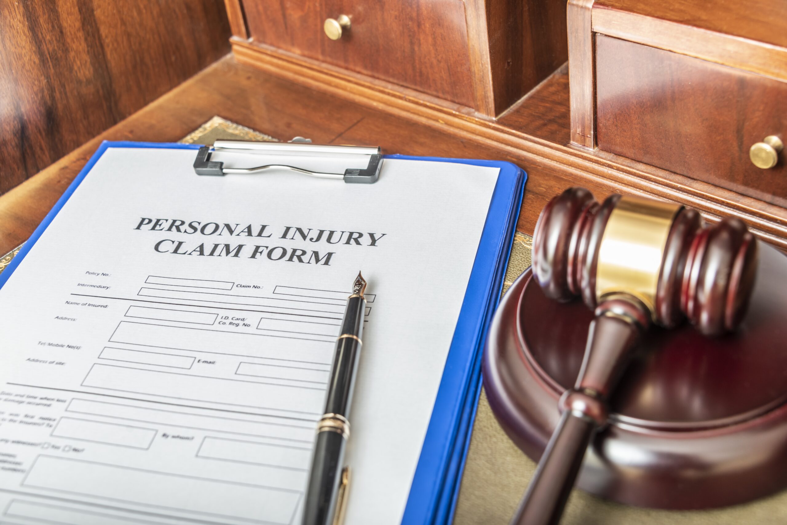 A personal injury claim form next to a judge's gavel.