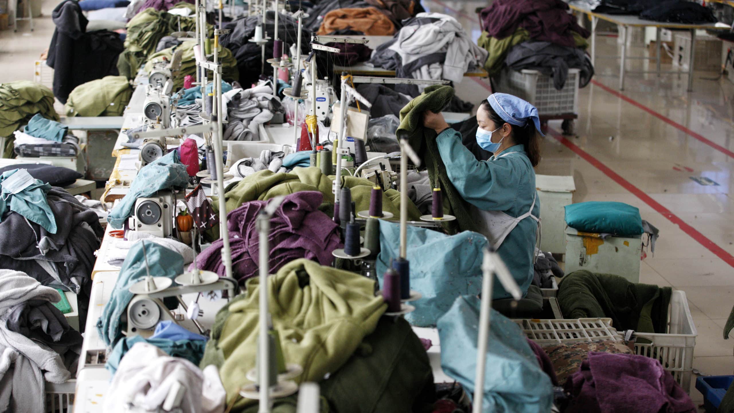 workers at a garment factory produce clothing.