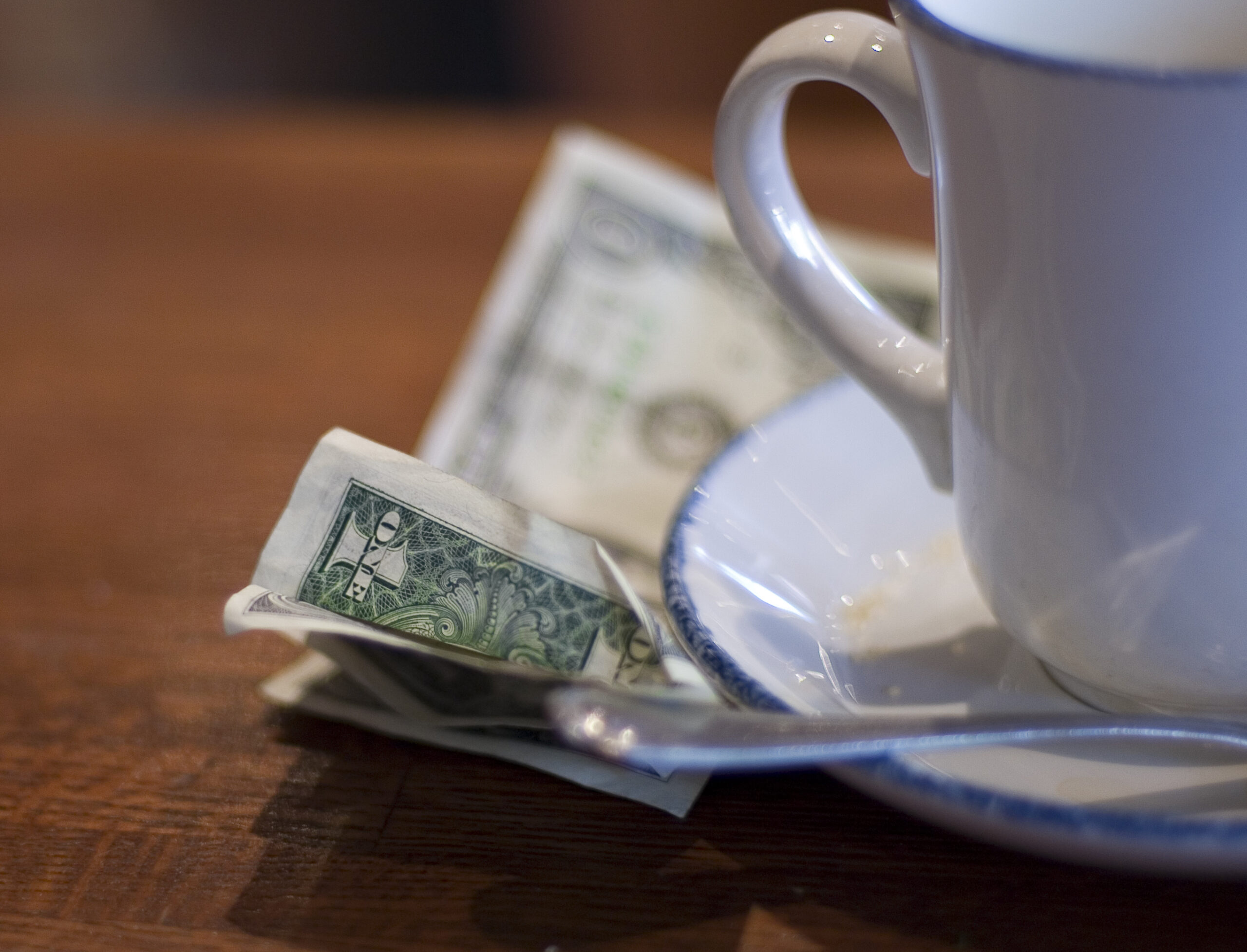 a tip sits next to a coffee mug.