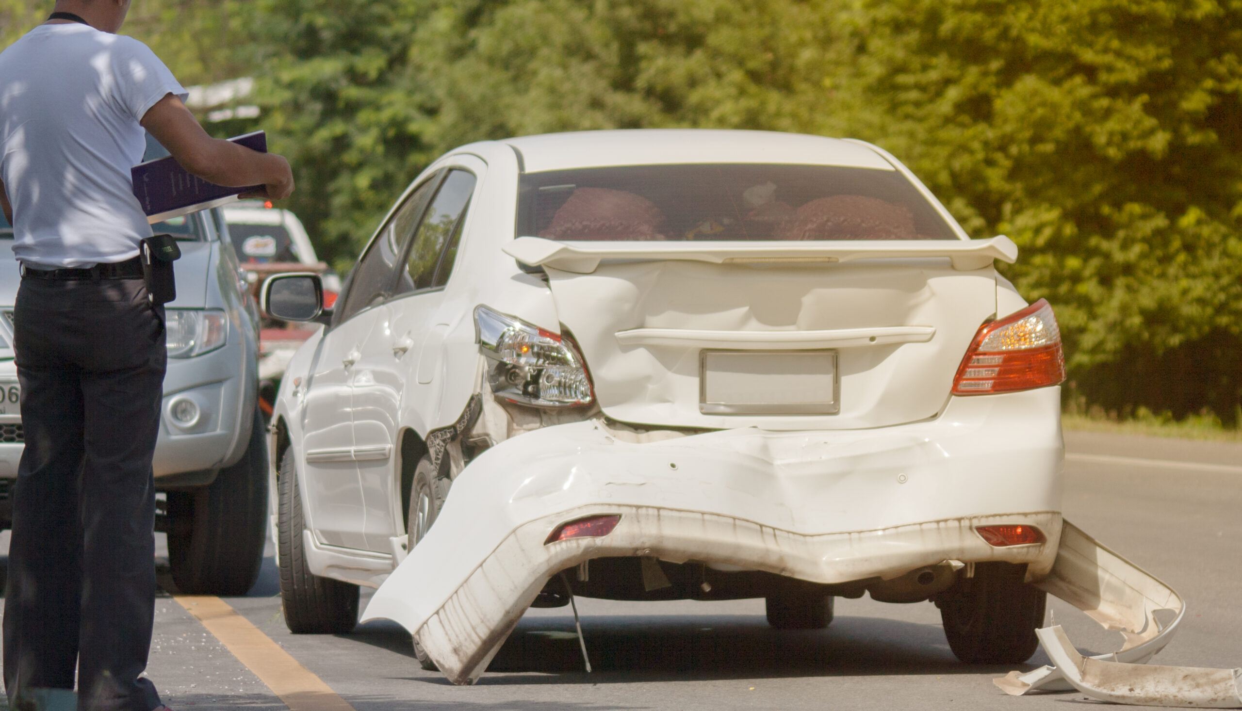 An insurance adjuster evaluates a vehicle