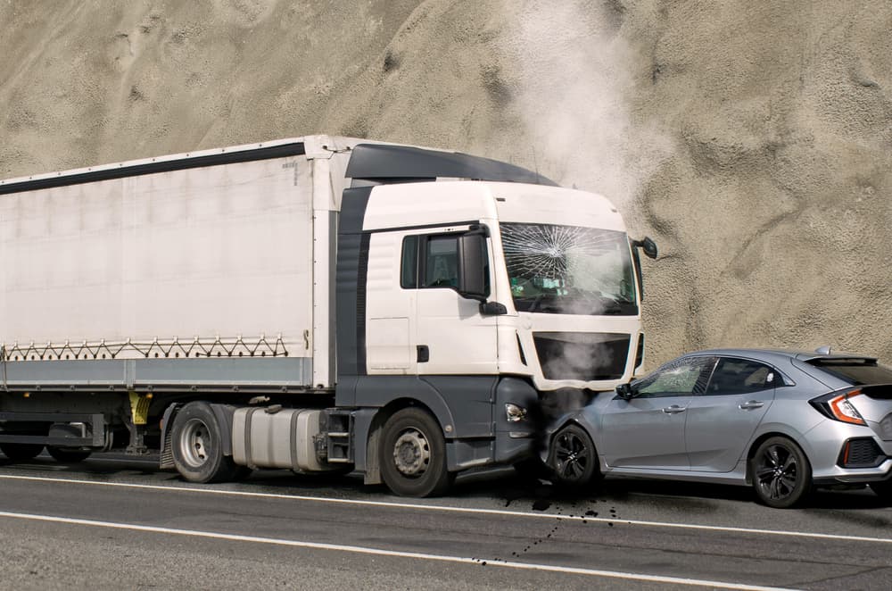 Collision involving a truck and car. Street accident caused by speed and negligence.