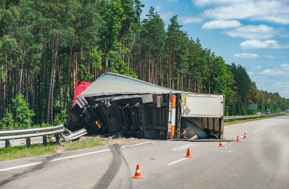 Accident on autobahn - rollover truck on road, car crush. Transportation background