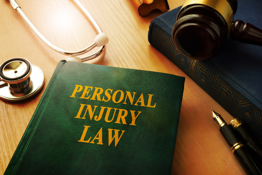 Personal injury law book on the table along with stethoscope