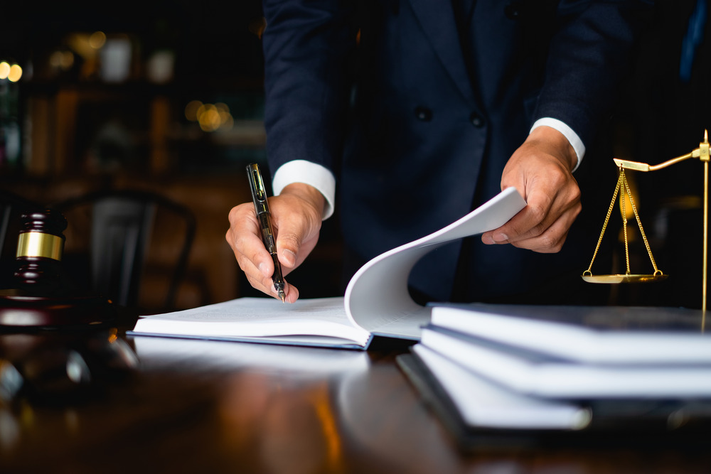 A personal injury lawyer signing the documents in court