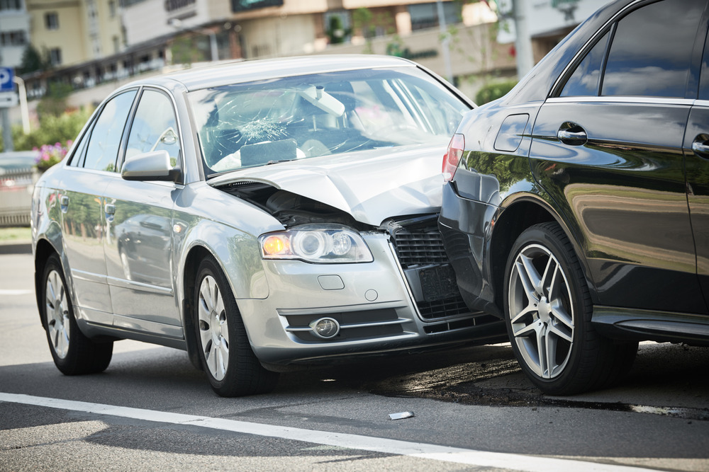 Collision between two cars. Front of the silver car is damaged