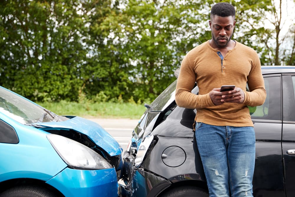 Male Motorist Involved In Car Accident Calling Insurance Company Or Recovery Service